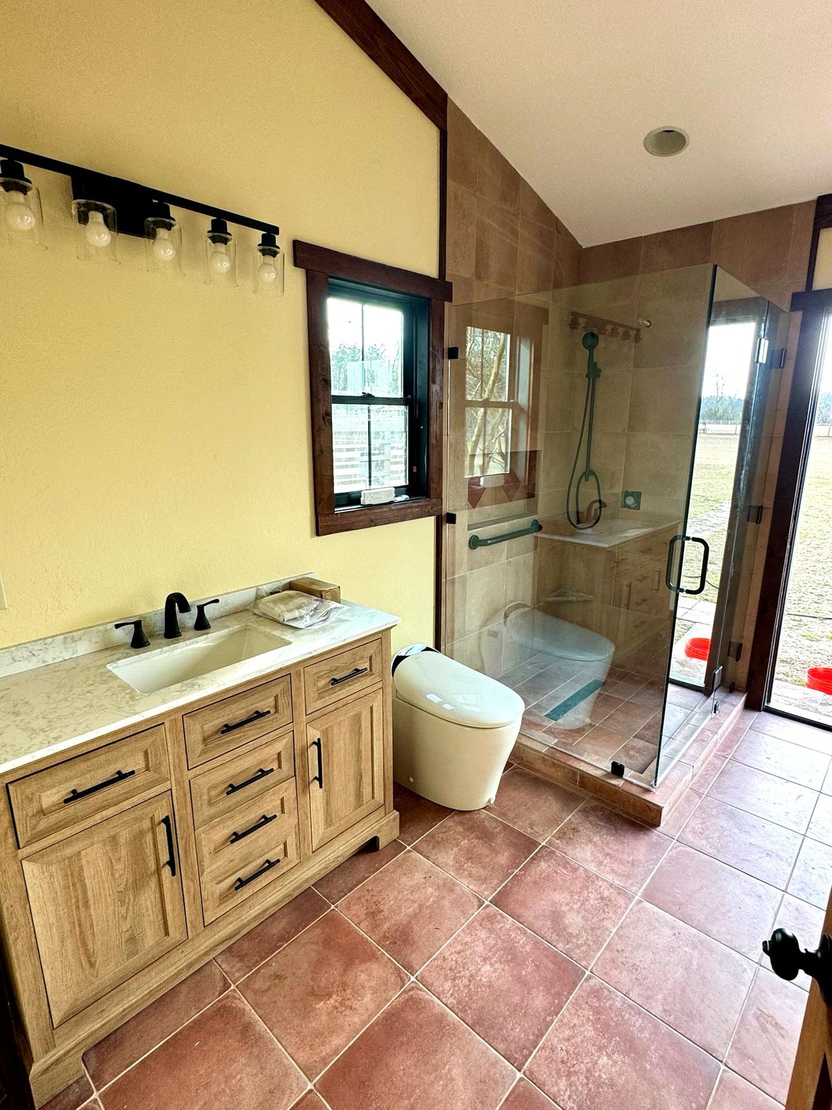Finished rustic bathroom with walk-in tile shower