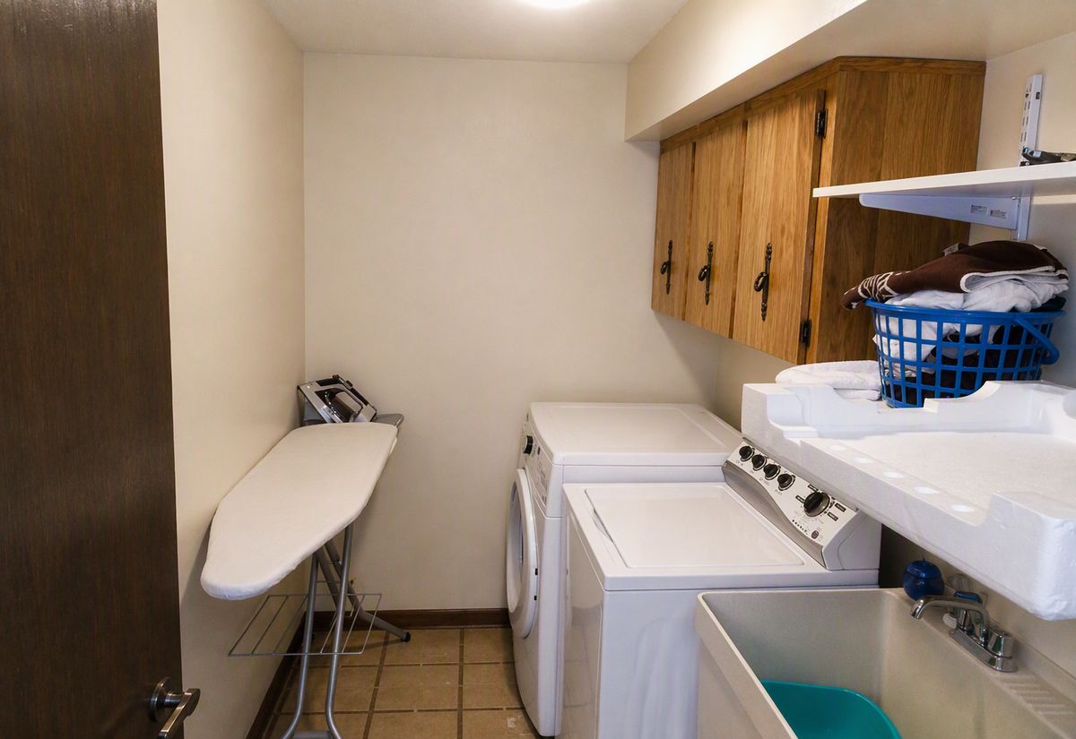 Dated laundry room before